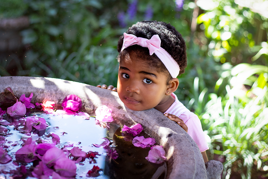 little girl at bird bath